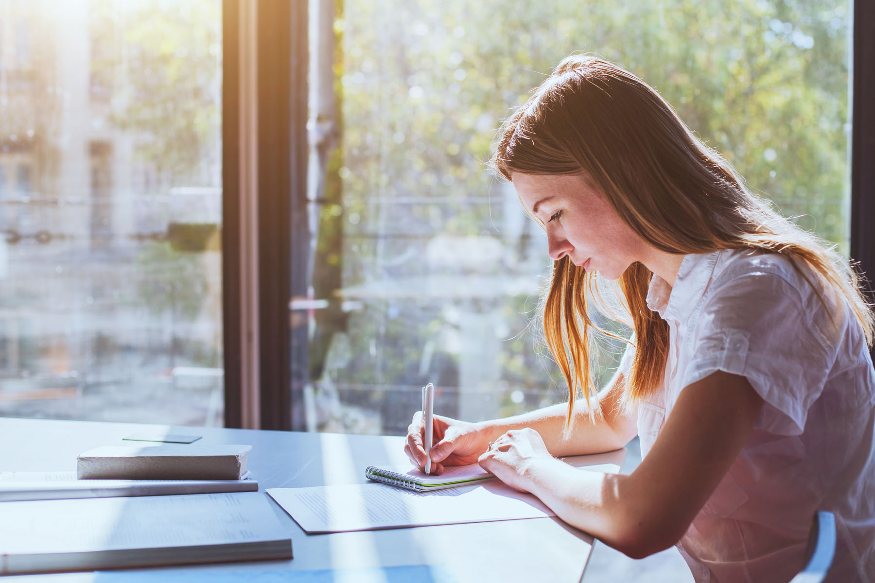 Photo of student sitting at a table taking an exam